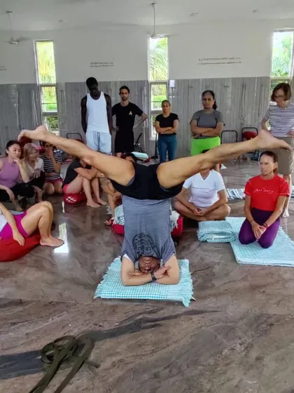 Demonstrating a headstand variation.