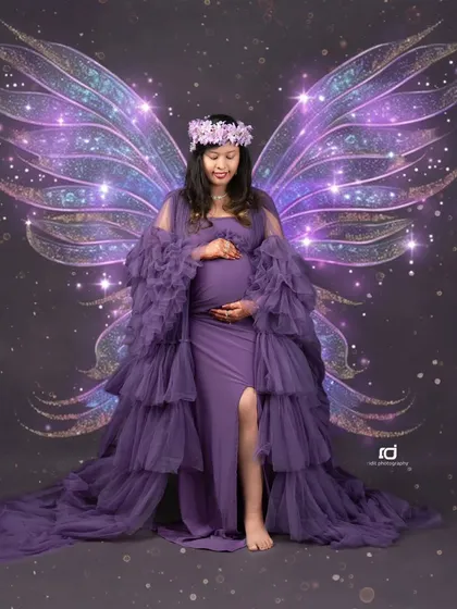 A touch of fantasy for your maternity shoot. With added fairy wings, this portrait in a purple gown transforms the mom-to-be into a magical guardian for her unborn child.