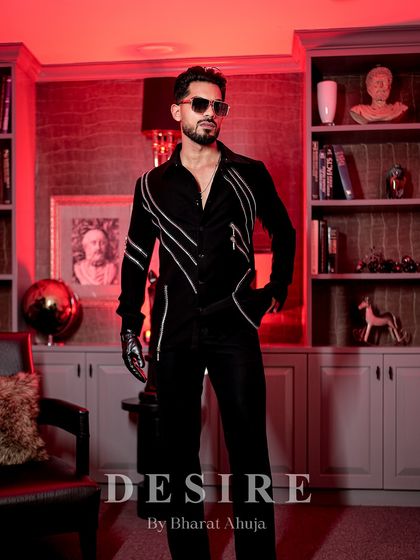Draped in darkness, defined by desire. This all-black shirt features sleek, diagonal lines of silver zipper detailing, adding a touch of modern, industrial edge to a classic silhouette.