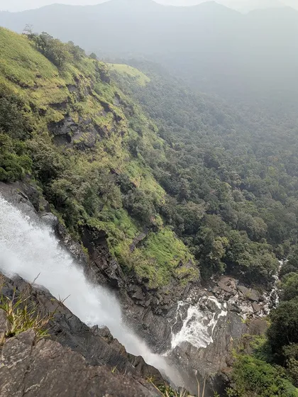 A breathtaking view from the top of Bandaje falls, looking down into the green valley.