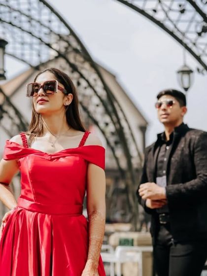 A close-up showing the beautiful off-the-shoulder neckline of our red satin gown. It's a romantic and flattering detail for your pre-wedding photos.