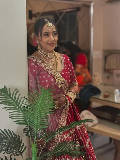 A happy, smiling bride captured in a relaxed moment. The makeup is designed to look fresh and beautiful, even in candid shots.