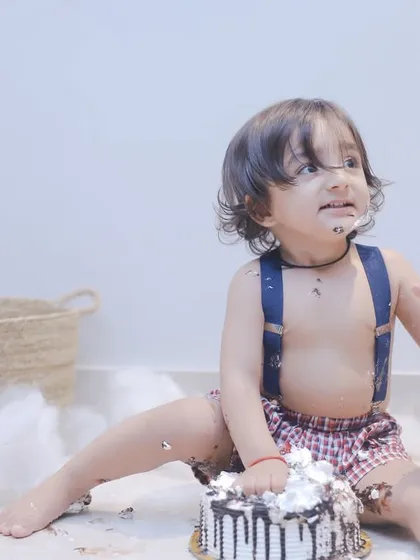 This little guy is getting right into his first birthday cake. We love capturing the hilarious and heartwarming chaos of a cake smash.