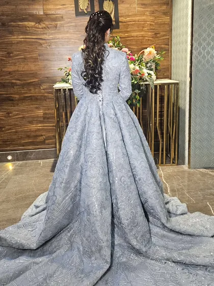 The back of the engagement gown, showing the dramatic train and the beautiful ponytail hairstyle we created.