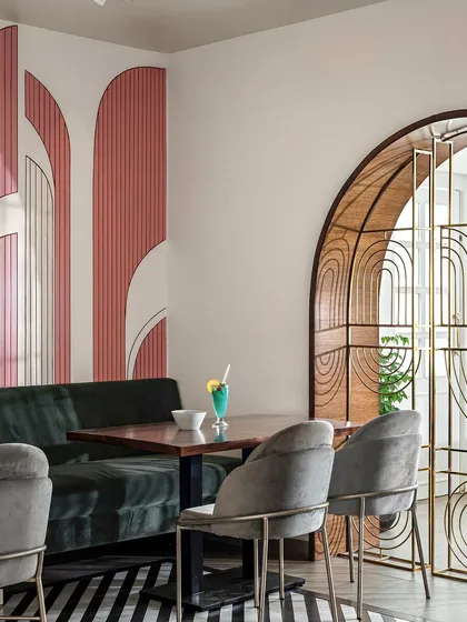 Details give a space its unique emotion, or 'olavu'. For the 'Pink Verranda' restaurant, I used art deco inspired arches in shades of pink to create a signature look. This is complemented by a custom metal-frame arch, blending modern art with heritage charm.
