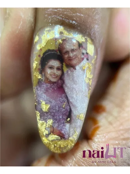 A truly personal touch. This father surprised his daughter on her wedding day by getting a photo of them printed on his nail. This is the ultimate custom nail art.
