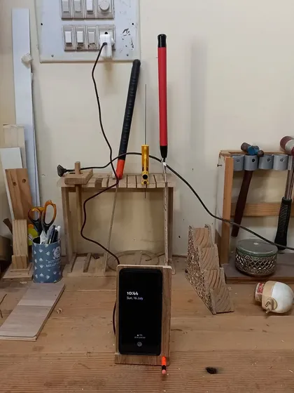 The wireless charging mobile stand in action. The most critical part of this build was routing out the wood to be just a millimeter thick over the charging coil.