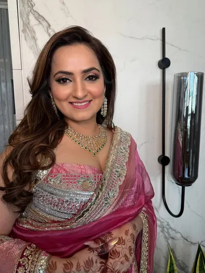 A happy client ready for her event with perfectly styled hair.
