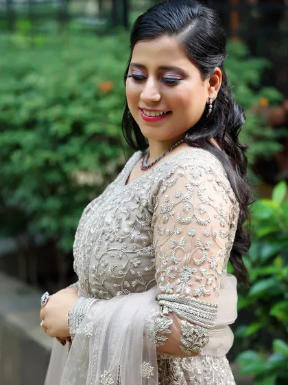 A side profile showing the soft half-up hairstyle and the glowing cheek highlight.