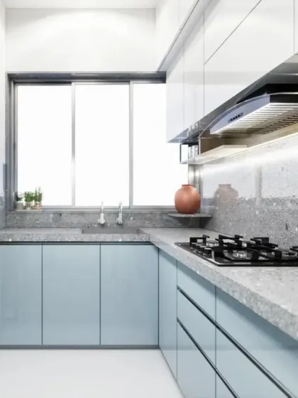 A full view of the L-shaped kitchen, showing the ample counter space and the bright, clean design.