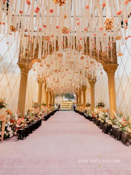 Your journey together should begin with a path of beauty. I crafted this immersive floral archway, dense with blooms and hanging tassels, to create a magical transition for the couple and their guests into the heart of the celebration.