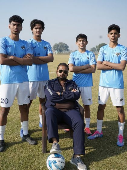 Living and breathing football since 1948. Our coach with some of our senior youth players, representing the legacy of the club.