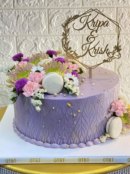 I love making cakes that match my brand colors! This lavender cake features a beautiful stencil pattern and is topped with fresh flowers and macarons.