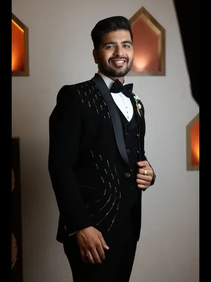 A stylish shot of the groom at his reception. The makeup is designed to look great under the warm lighting of an evening event.