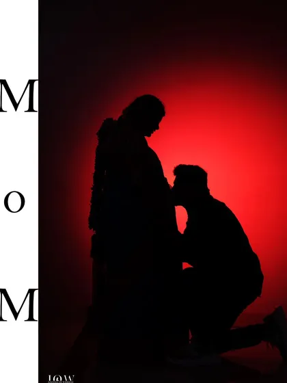A powerful silhouette of an expecting mother being embraced by her partner, set against a dramatic red background. This artistic maternity photo shows my ability to tell stories of love and family at every stage.