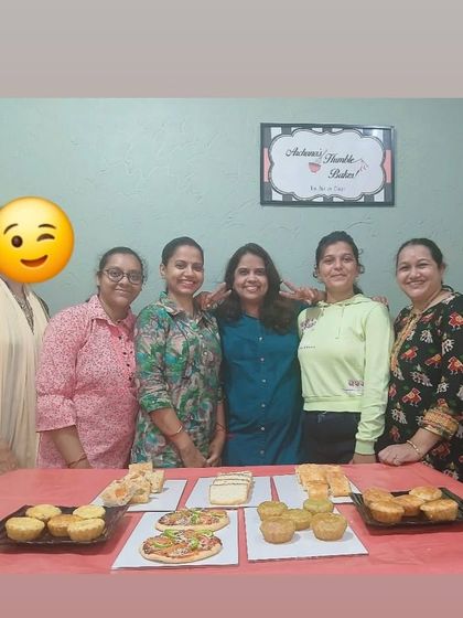 A proud moment with my students after a successful yeast-free bread workshop, with a full table of their baked goodies like pizzas, pav, and focaccia.