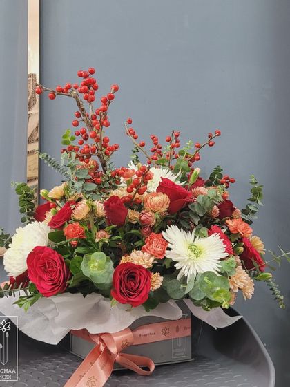 This arrangement uses bold reds and berries to create a festive and joyful mood. Learning to control mood is a key skill for any floral designer.
