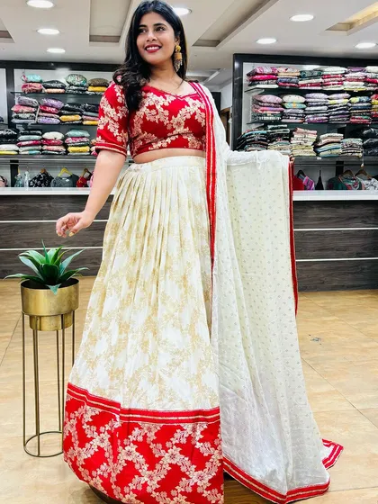 This red and white lehenga is a classic combination for Navratri. The printed skirt is paired with a beautifully embroidered red blouse, creating a festive and elegant look.