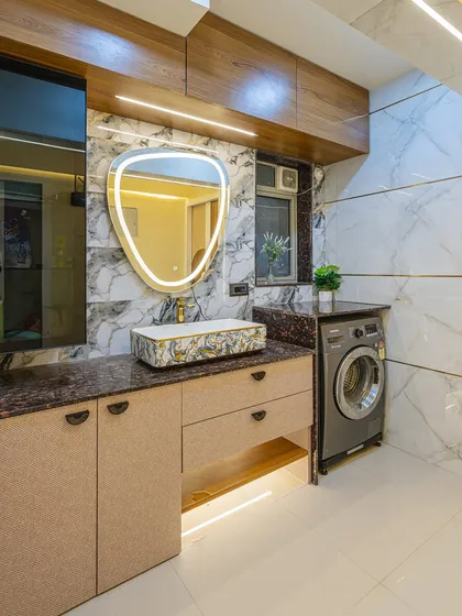 I believe every corner of a home should be functional. Here, I converted what was an extra washroom into a practical laundry area, complete with a stylish countertop basin, storage, and a dedicated spot for the washing machine.