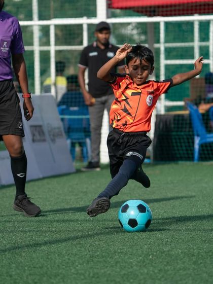 A young Lion unleashes a powerful shot on goal during a competitive game.