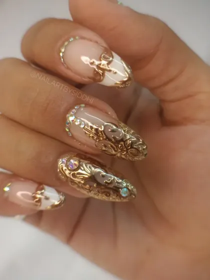 A full-hand view of the stunning gold filigree nail art, showing how the design works across all nails.