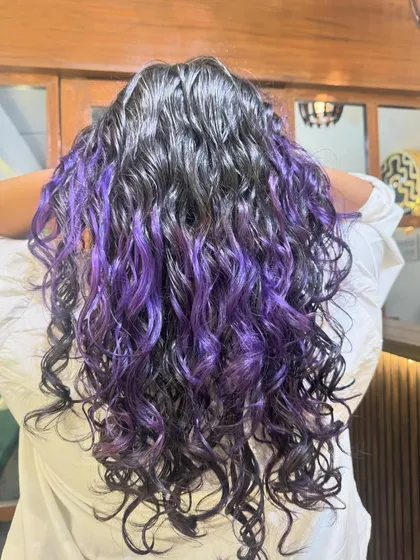 Another angle of the vibrant purple highlights, showing how they blend with the dark hair.
