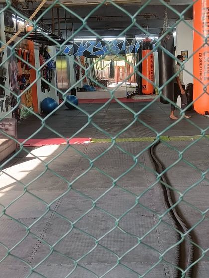 Our Greater Noida club has been upgraded with many new features. This view through the cage shows the spacious training area and equipment waiting for you. Visitors are always welcome.