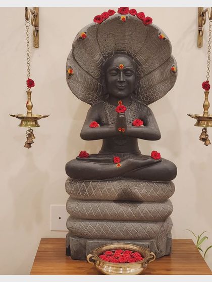 A statue of Maharshi Patanjali, the sage of yoga, adorned with flowers in our shala. His presence is a constant reminder of the deep lineage and wisdom we are a part of.