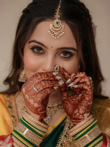 A playful shot of the bride with her nath, her eyes sparkling.