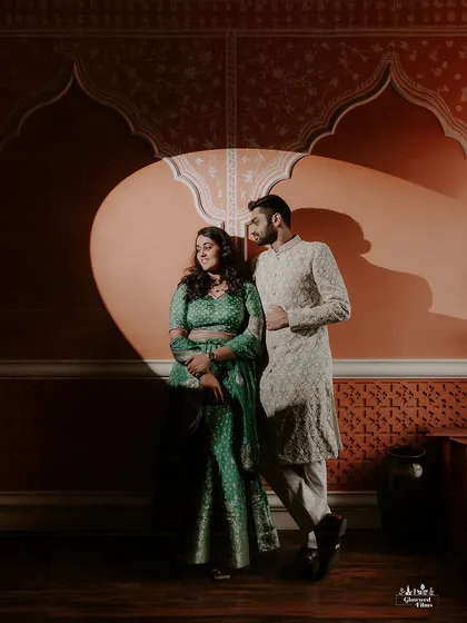 In the studio, we play with light and shadow to create dramatic, artistic portraits. This image uses a single spotlight to highlight the couple against a richly textured, Rajasthani-inspired backdrop, showcasing our versatility in a controlled creative environment.