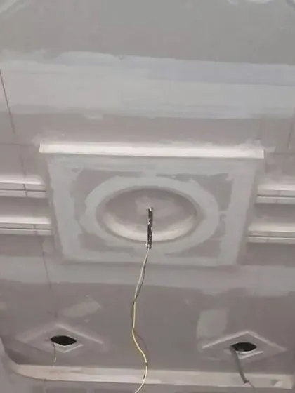 A classic tray ceiling design with a central circular medallion, shown in its raw POP state.