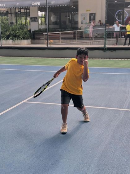 A young player shows his fighting spirit after winning a point. We teach our junior players to be expressive and passionate on the court while maintaining sportsmanship.