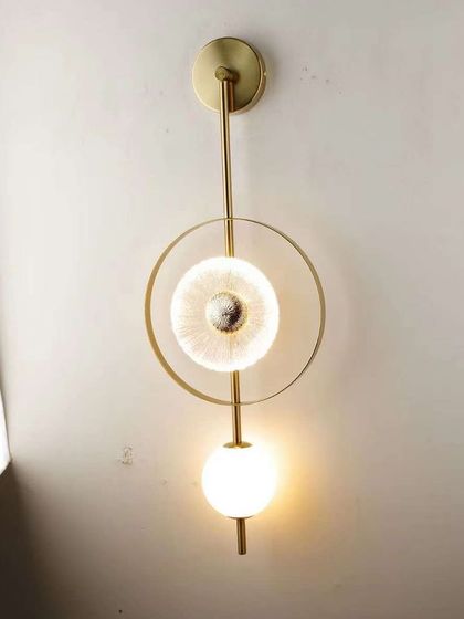 A variation of our geometric wall sconce, shown here in a vertical orientation. It's a versatile piece for modern interiors.