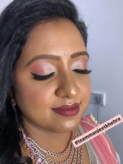 A close-up of the reception eye makeup. The blend of shimmery champagne and soft pink eyeshadow creates a romantic and elegant feel, perfect for an evening celebration.