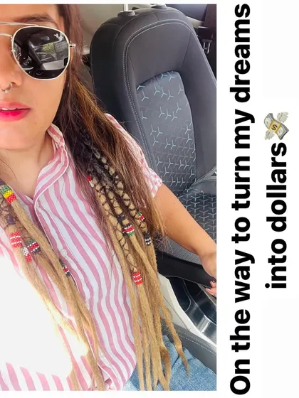 I live the loc life myself. This is me with my own partial dreadlock extensions, styled with colorful beads. I believe in my work, and I love creating styles that are both beautiful and easy to wear every day.