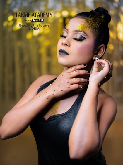 This shot showcases a fantasy glam look with gold embellishments on the hands and a dramatic pose. We teach students to think about the entire concept, not just the face.