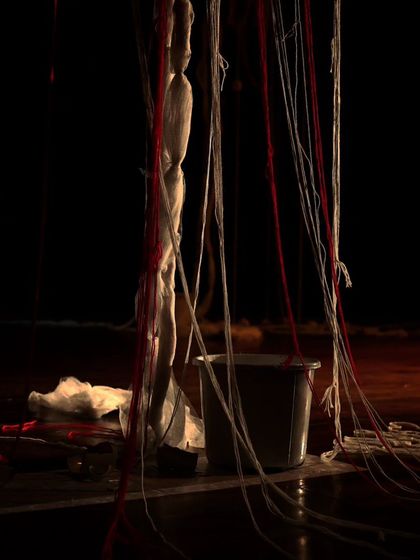 The set for "Medea," featuring a mannequin and a bucket.