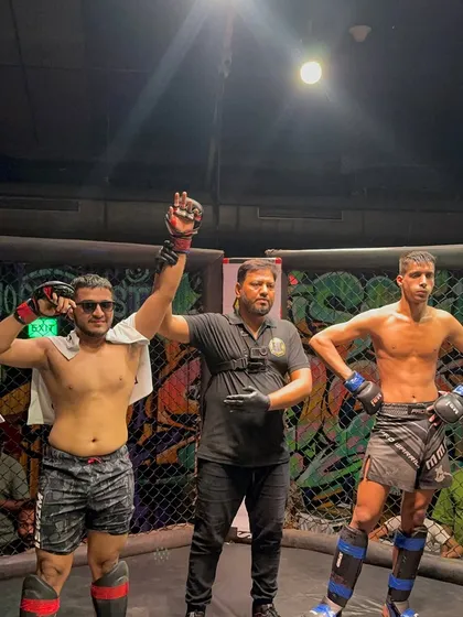 The moment of victory. I stand with my fighter Vraj after he secured a win by unanimous decision. My job is to guide them, their job is to dominate.