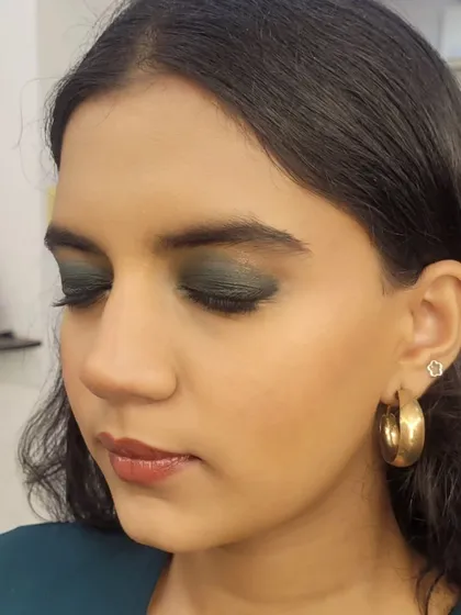 A side profile showing the seamless blend of the green and black eyeshadows for this formal smokey eye look.