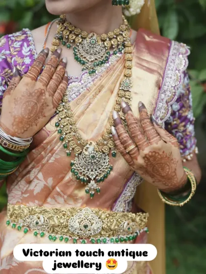 For a touch of royal elegance, I offer Victorian-style antique jewellery. This close-up shows the beautiful detail in the choker, long necklace, and waist belt, all studded with green stones to perfectly complement a silk saree.