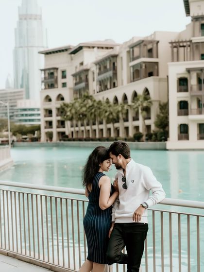 An intimate moment against the backdrop of the Dubai Canal, showing the blend of urban life and romance.