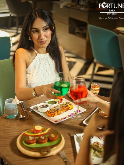 Toasting to friendship at Zodiac. Our menu includes a variety of colorful mocktails and cocktails to complement your meal.