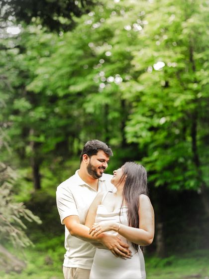 A happy, smiling embrace, celebrating the "yes" in a beautiful natural setting.