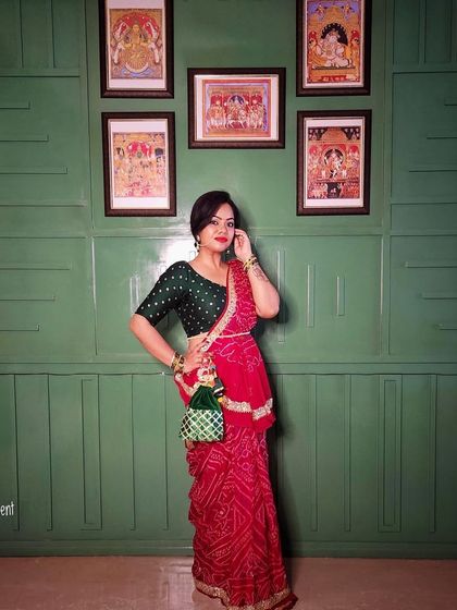 A stunning red bandhani saree paired with a contrasting green blouse. This look is a beautiful blend of traditional prints and rich colors, perfect for any celebration.
