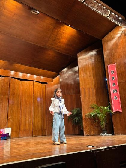 A student delivers her lines with confidence and clarity during her solo moment in the spotlight.