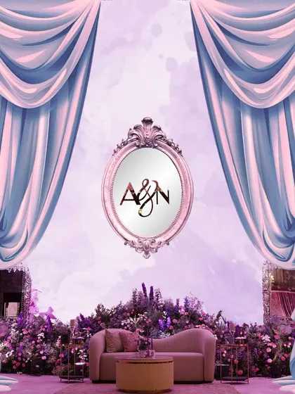 A conceptual graphic of the fairytale stage, with powder-blue drapes parting to reveal a vintage mirror and a lounge area surrounded by lavender blooms.