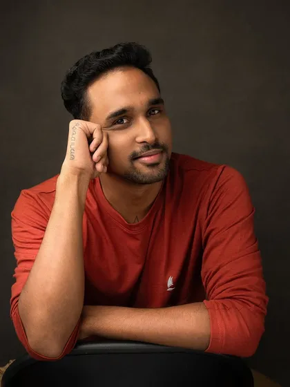 A more relaxed and casual portrait from the same session. His easy smile and comfortable pose show a different side of his personality, highlighting the trust we built during the shoot.