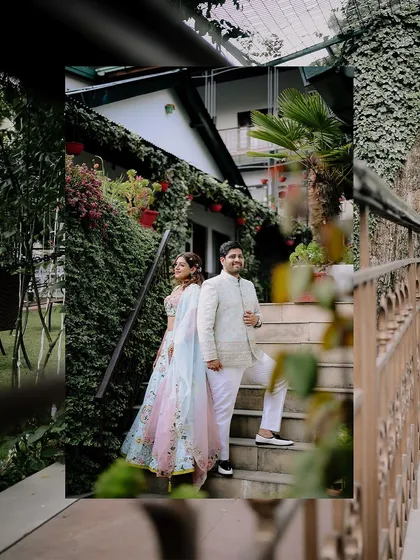 A stylish portrait of the couple posing on a staircase at their destination engagement venue. The composition uses the architecture to frame them beautifully.