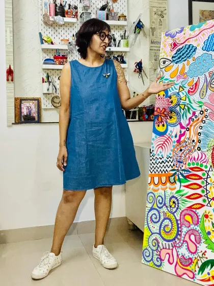 Showing off my work-in-progress. The colors of the painting and my dress create a nice contrast.