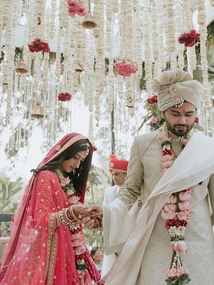 The sacred pheras walk. This couple is surrounded by a canopy of hanging flowers and bells, a traditional setup we designed to add a sense of sanctity and beauty to the ceremony.